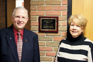 Two class of ’64 reunion committee members, Deacon Jerry Franzen and Elaine Kohlhepp pictured with the newly installed classroom plaque.