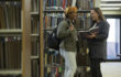 Women talking in library