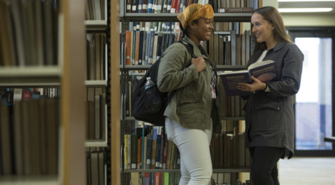 Women talking in library