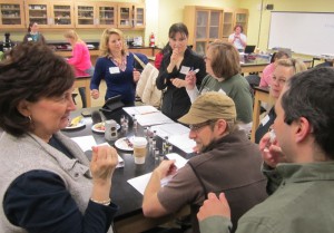 High school teachers having fun testing each other on identifying plant-derived scents with Dr. Bill Wetzel (Thomas More College, Chemistry), seen lower right.
