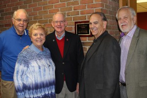 Pictured are five of the seven Class of 1965 reunion committee members along with the newly installed classroom plaque: Bill Van Lokeren (from left), Marie (Brue) Shields, Lou Esselman, Mick Goldberg, and Tony Zembrodt. Committee members not pictured are Jim Stautberg and Marlene (Geiman) Robinson.
