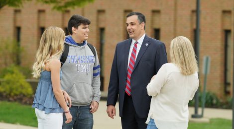President Joseph L. Chillo, LP.D., with students on the Thomas More University campus