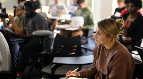 Attentive students in classroom setting taking notes in a lecture setting