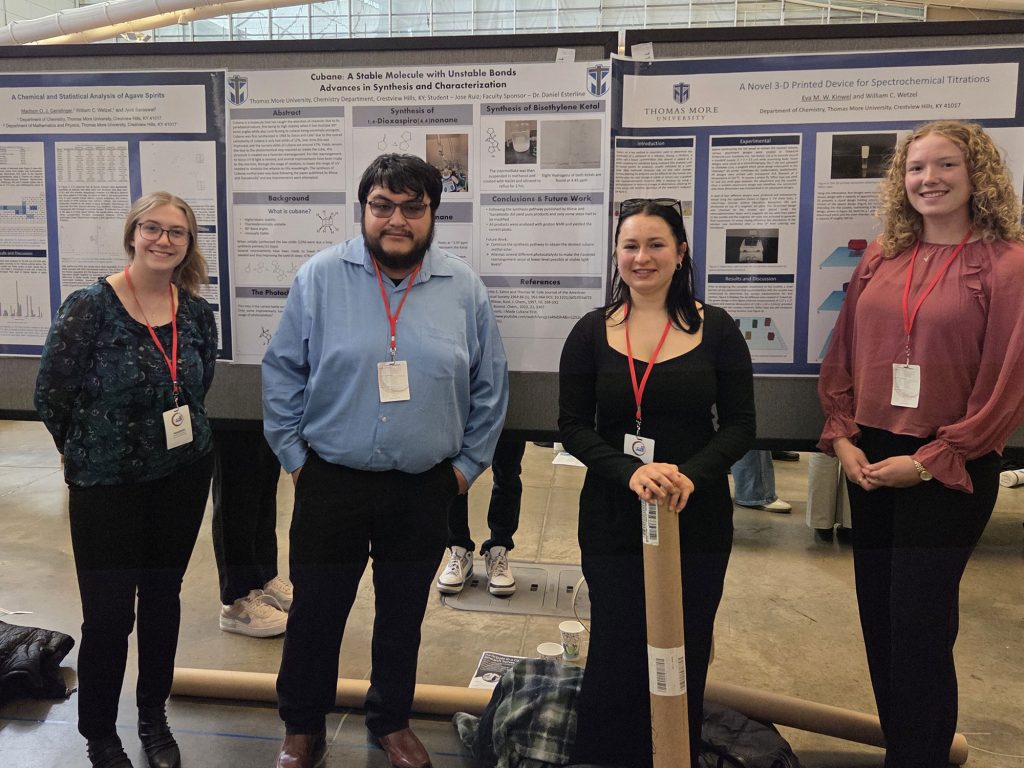 Thomas More student researchers Madison Genslinger, Eva Kinwel, Paige Robbins, and Jose Ruiz with their poster presentations.
