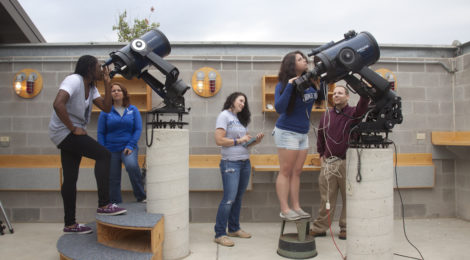 people looking through telescopes