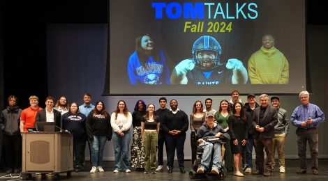 Group on stage celebrating the December 2024 Tom Talks.